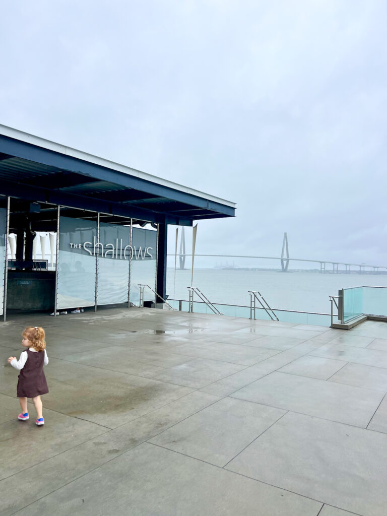 my toddler outside the south carolina aquarium on a rainy day in charleston, sc.