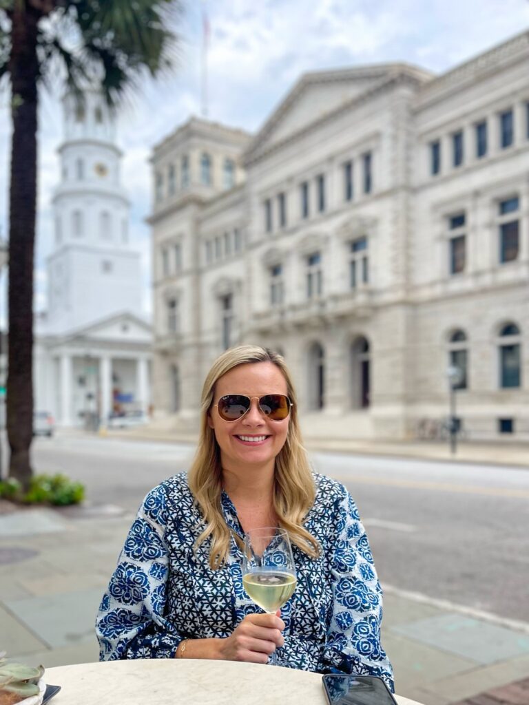Me dining outside at Sorelle in Charleston, SC with the view of St Michaels Church behind me.